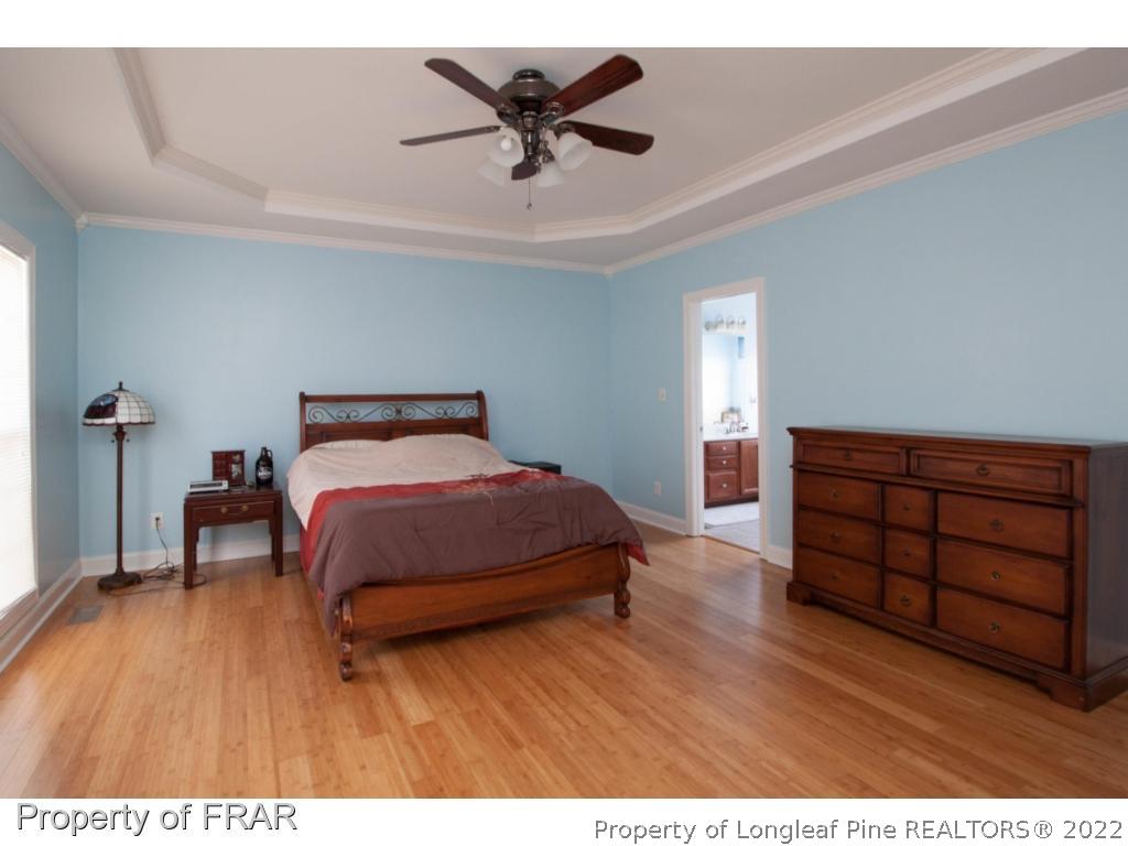 510 Booth Pond Road Raeford, NC 28376 - Photo 23 of 36 a bedroom with a bed and a ceiling fan