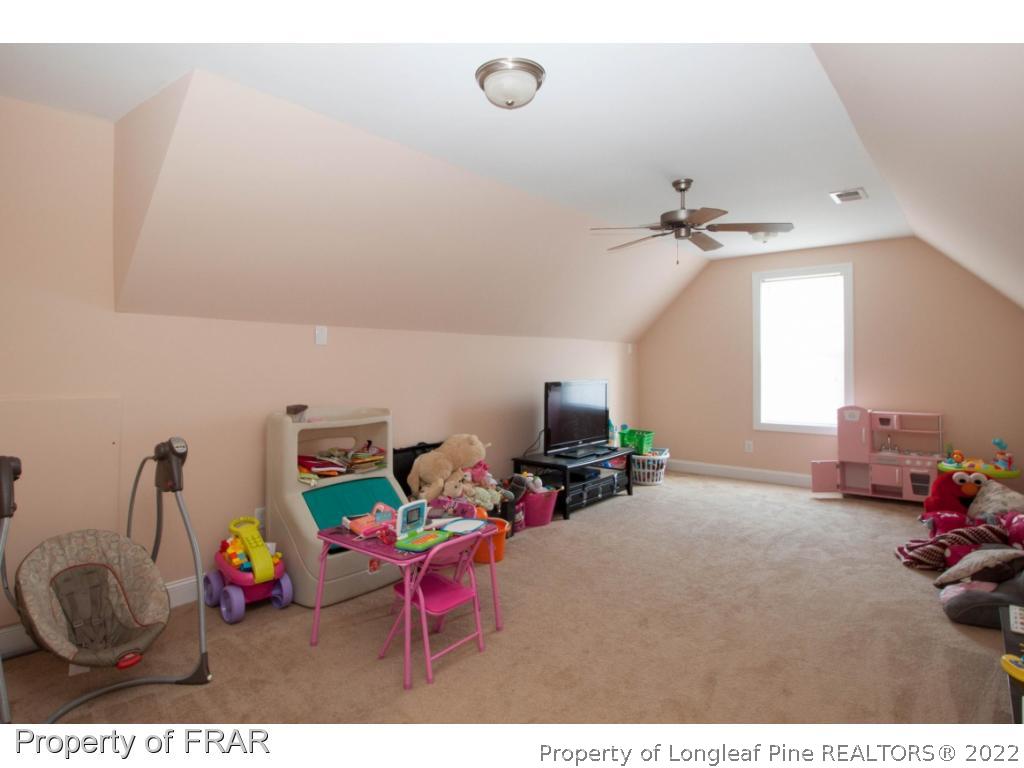 510 Booth Pond Road Raeford, NC 28376 - Photo 27 of 36 a living room with furniture a flat screen tv and a window