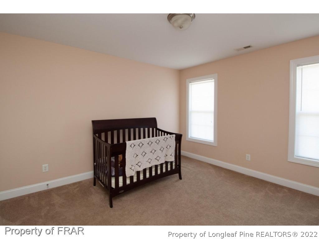 510 Booth Pond Road Raeford, NC 28376 - Photo 28 of 36 a bed sitting in a bedroom next to a window