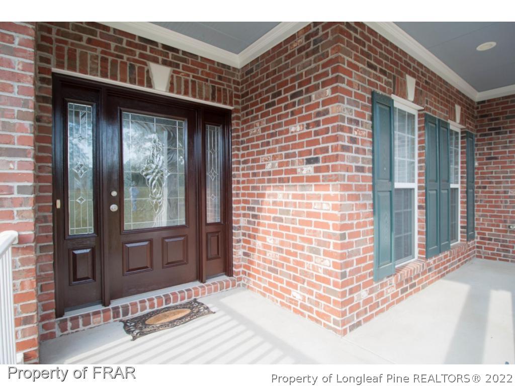 510 Booth Pond Road Raeford, NC 28376 - Photo 4 of 36 a view of a brick house with windows