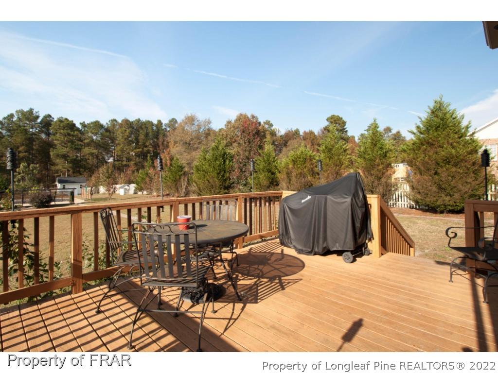 510 Booth Pond Road Raeford, NC 28376 - Photo 6 of 36 a view of a balcony with wooden floor and fence