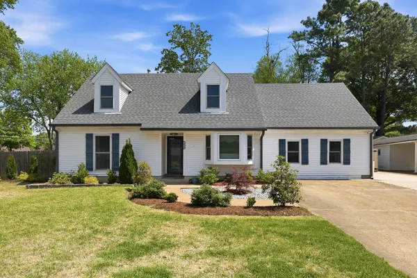 a front view of house with yard and green space
