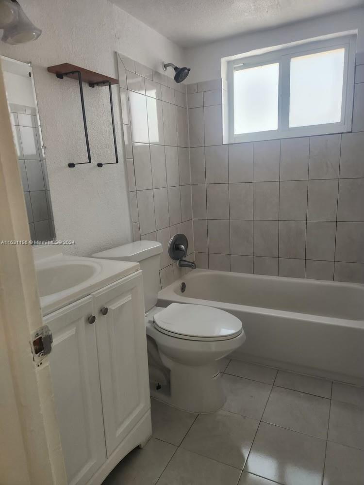 10 Northwest 48th Place, Unit 1 Miami, FL 33126 - Photo 4 of 10 a bathroom with a toilet a sink and bathtub