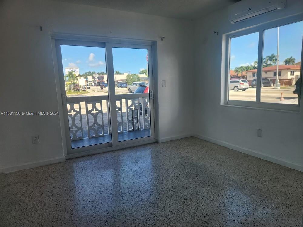 10 Northwest 48th Place, Unit 1 Miami, FL 33126 - Photo 5 of 10 an empty room with windows and city view