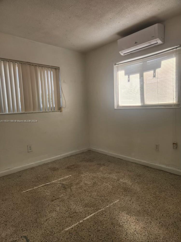 10 Northwest 48th Place, Unit 1 Miami, FL 33126 - Photo 9 of 10 an empty room with windows