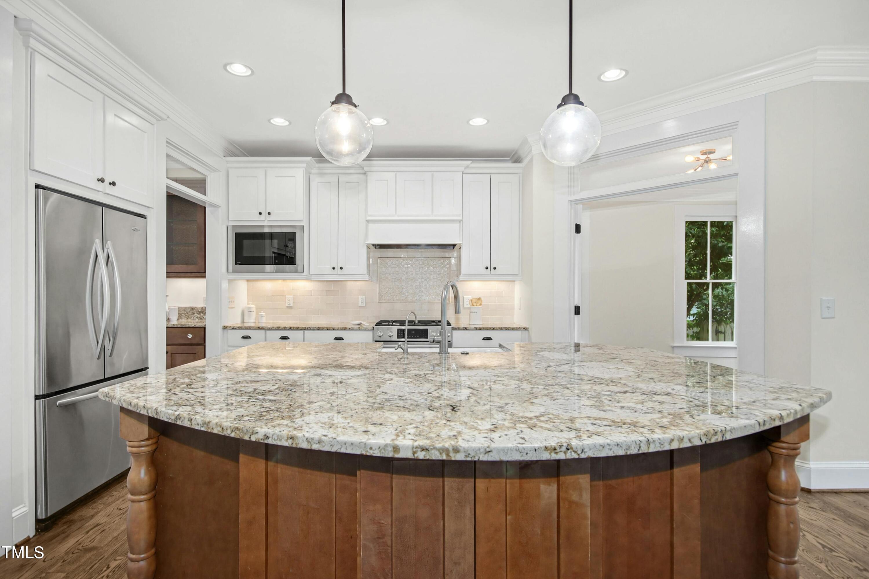 512 Peebles Street Raleigh, NC 27608 - Photo 15 of 45 a view of kitchen with sink refrigerator and microwave