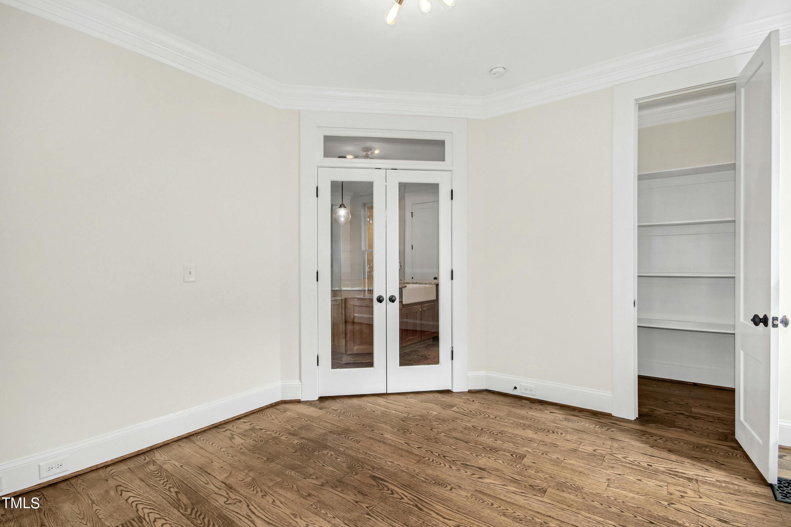 512 Peebles Street Raleigh, NC 27608 - Photo 21 of 45 a view of an empty room with wooden floor and closet