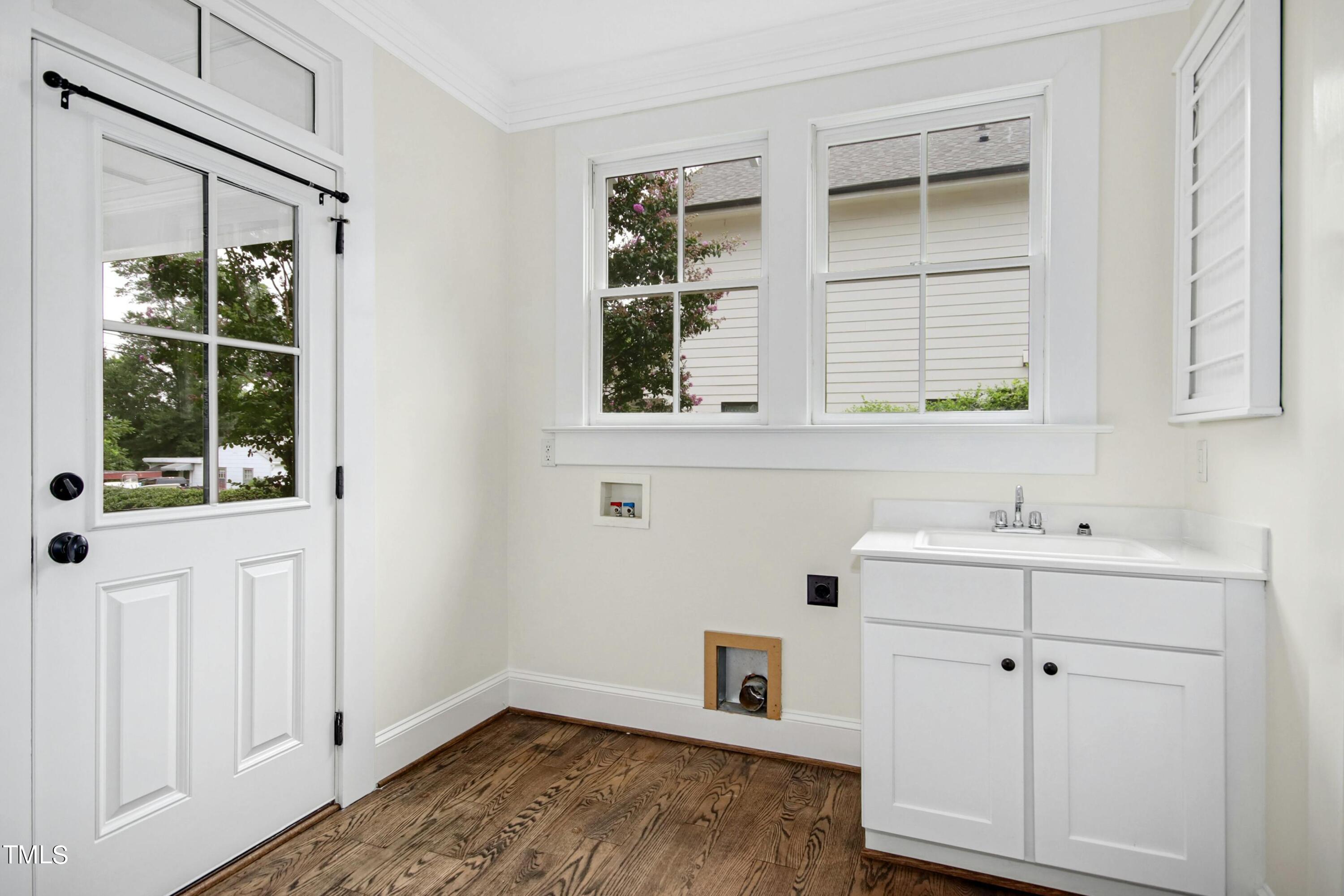 512 Peebles Street Raleigh, NC 27608 - Photo 23 of 45 a view of a bathroom with a sink and dishwasher next to a window