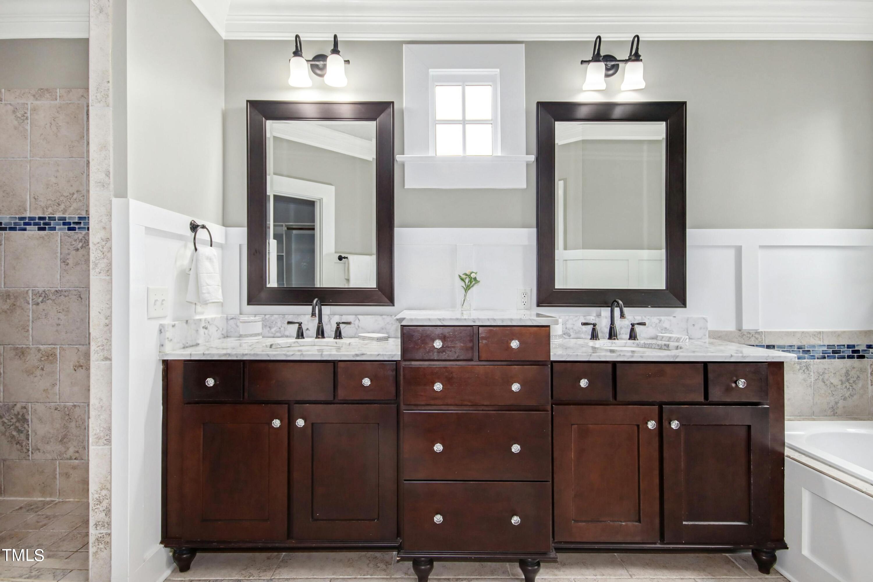 512 Peebles Street Raleigh, NC 27608 - Photo 29 of 45 a bathroom with a double vanity sink and a mirror