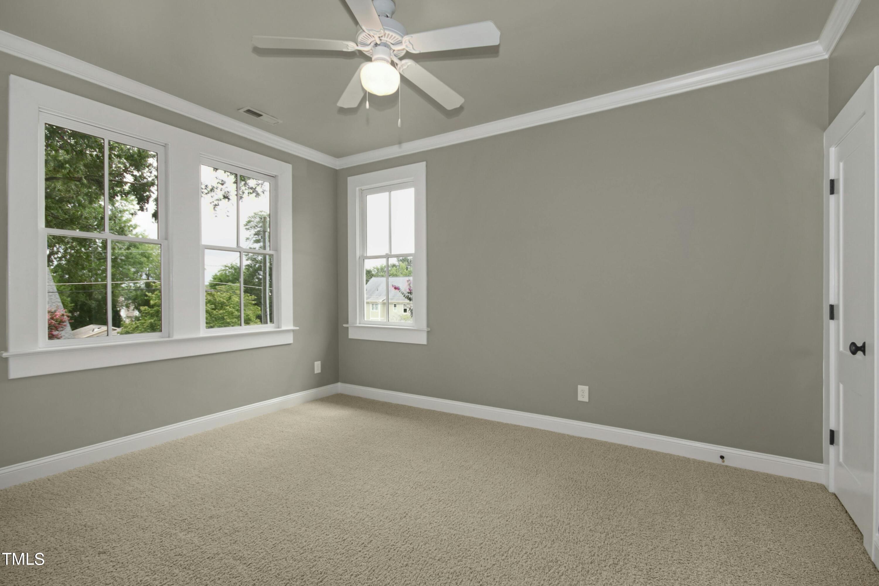 512 Peebles Street Raleigh, NC 27608 - Photo 33 of 45 an empty room with a window and a fan