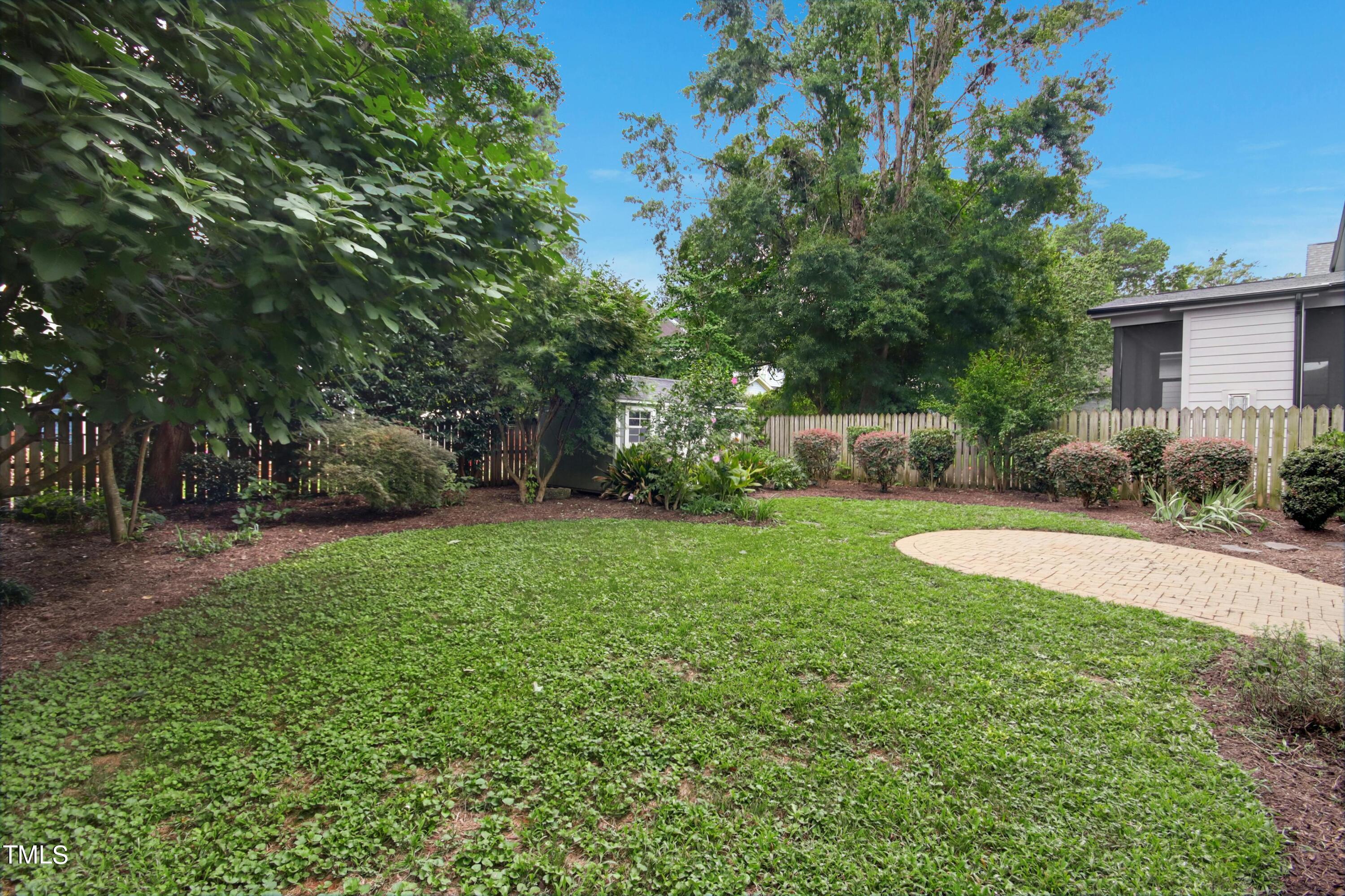 512 Peebles Street Raleigh, NC 27608 - Photo 41 of 45 a view of a backyard with a garden