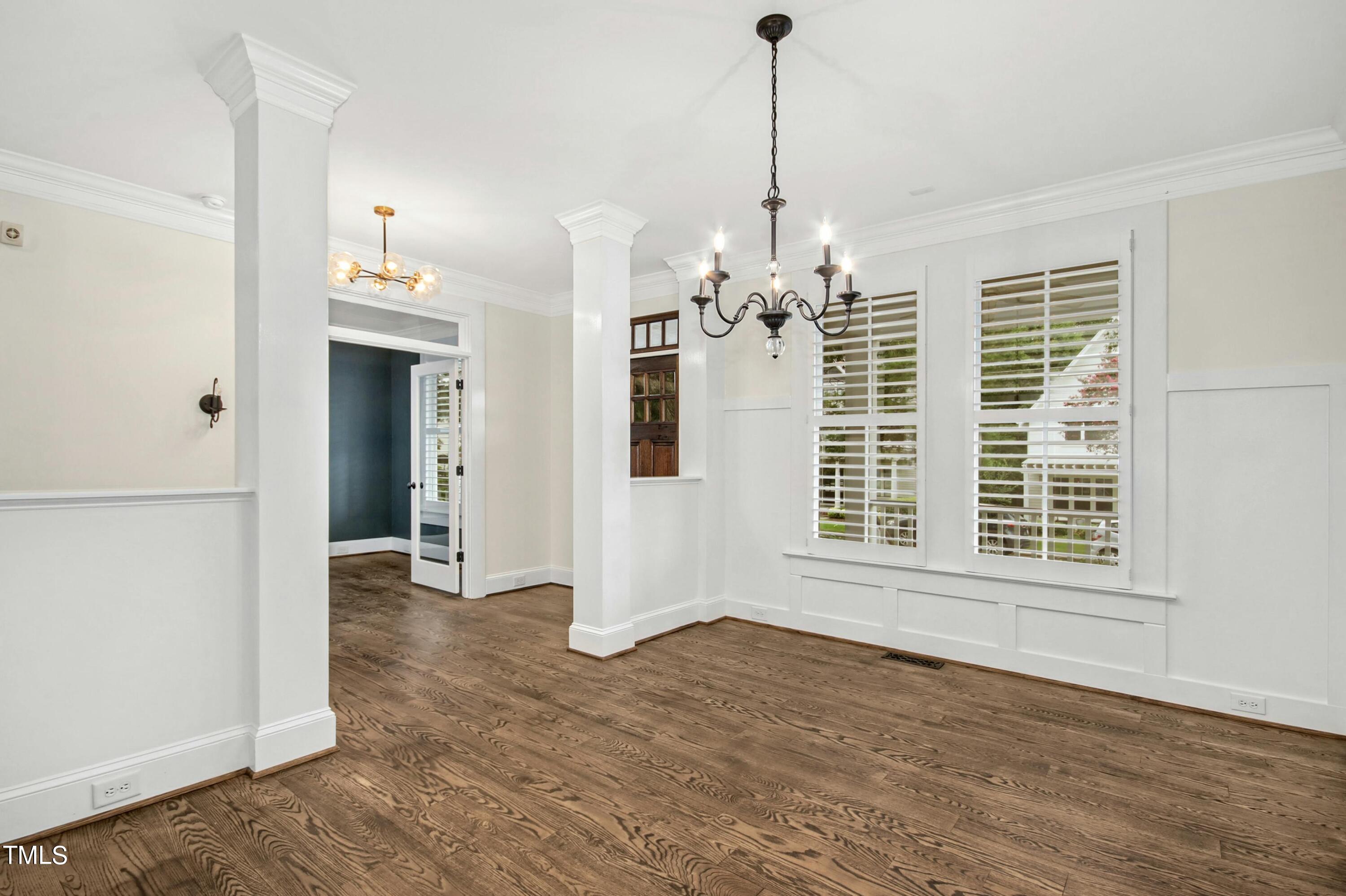 512 Peebles Street Raleigh, NC 27608 - Photo 8 of 45 a view of an empty room with wooden floor and a window