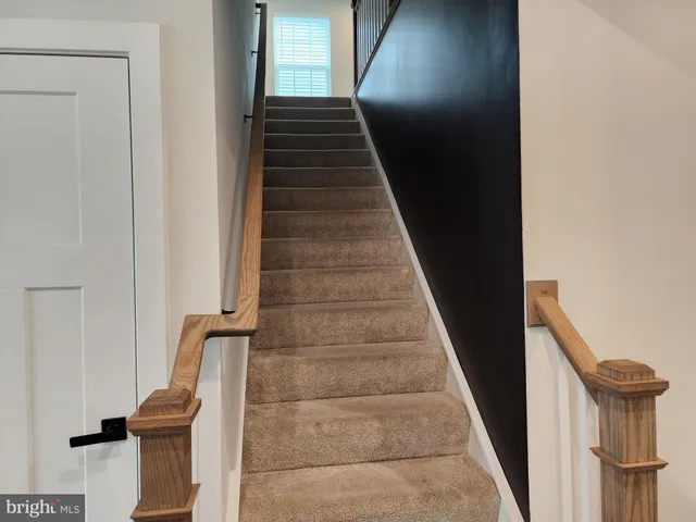 a spacious bedroom with a bed lamp and window