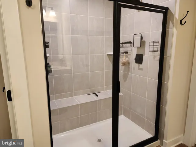 a bed sitting in a bedroom next to a window and a larger closet