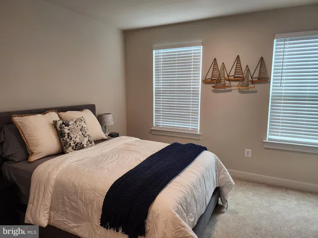 a view of a livingroom with workspace and a couch