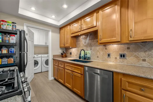 a kitchen with a sink cabinets and window