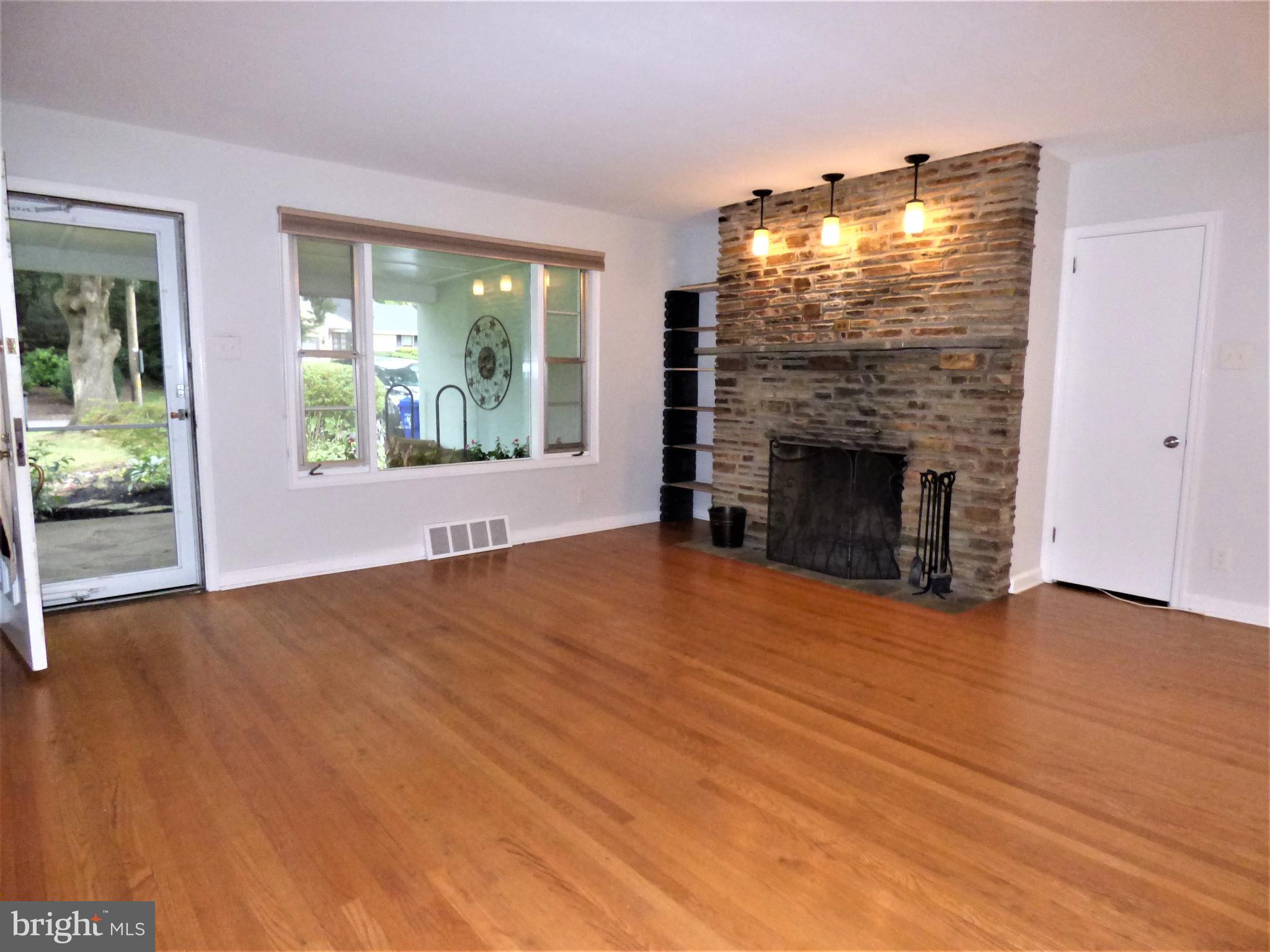 8033 Hammond Road Cheltenham, PA 19012 - Photo 6 of 38 Living Room - Highlighted by Stone Fireplace