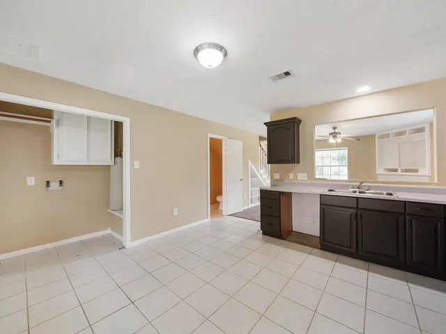 a large kitchen with a stove a sink and a refrigerator