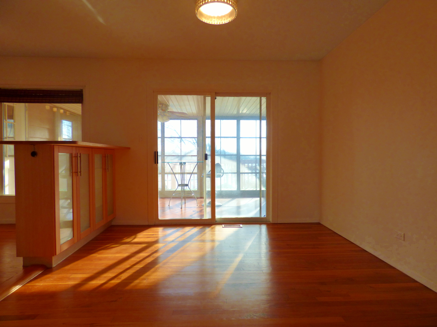 1345 Hassell Drive Hoffman Estates, IL 60169 - Photo 12 of 36 a view of an empty room with wooden floor and a window
