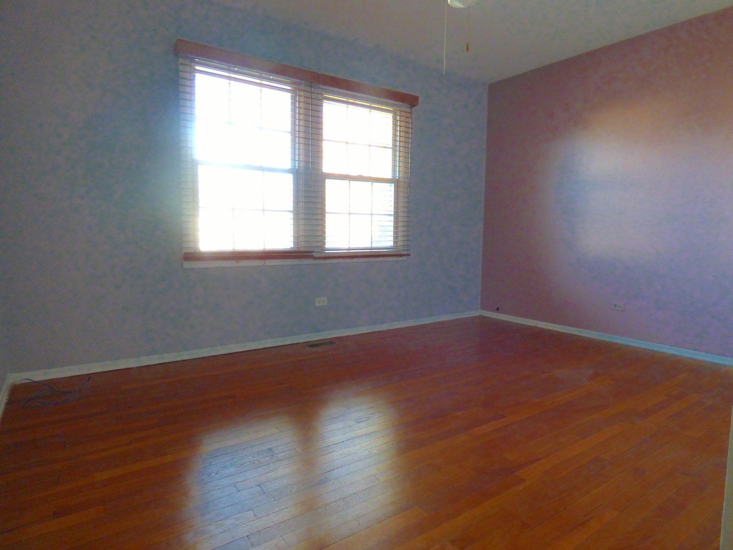 1345 Hassell Drive Hoffman Estates, IL 60169 - Photo 18 of 36 an empty room with wooden floor and windows