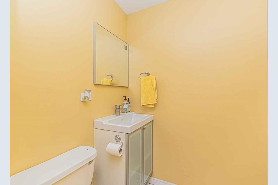 1345 Hassell Drive Hoffman Estates, IL 60169 - Photo 26 of 36 a bathroom with a sink a toilet and a mirror