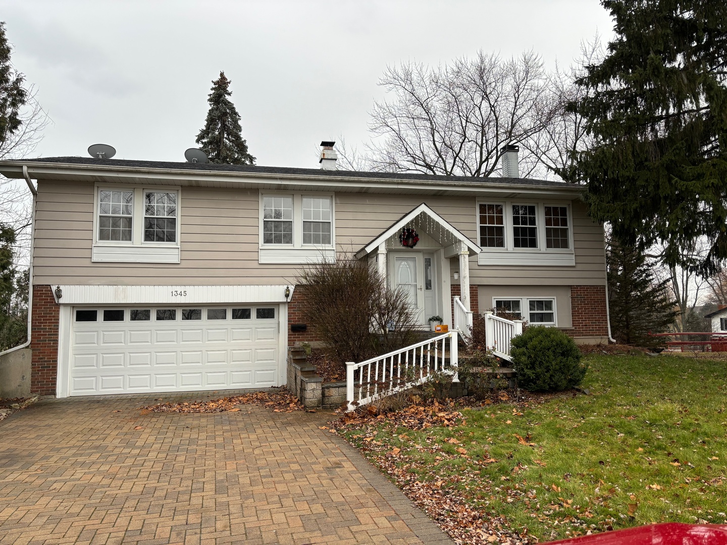 1345 Hassell Drive Hoffman Estates, IL 60169 - Photo 36 of 36 a front view of a house with a yard
