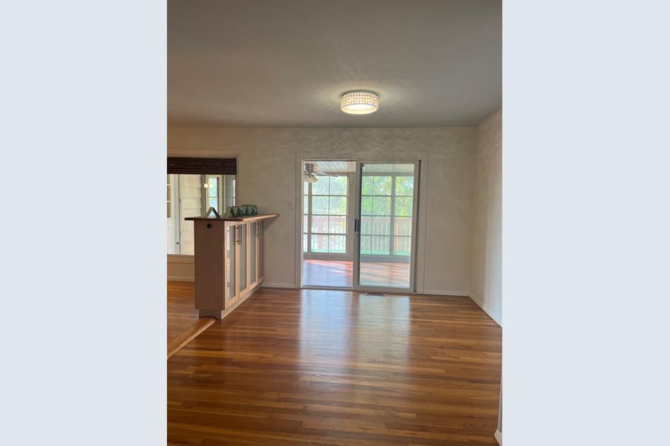 1345 Hassell Drive Hoffman Estates, IL 60169 - Photo 10 of 36 a view of an empty room with wooden floor and a window
