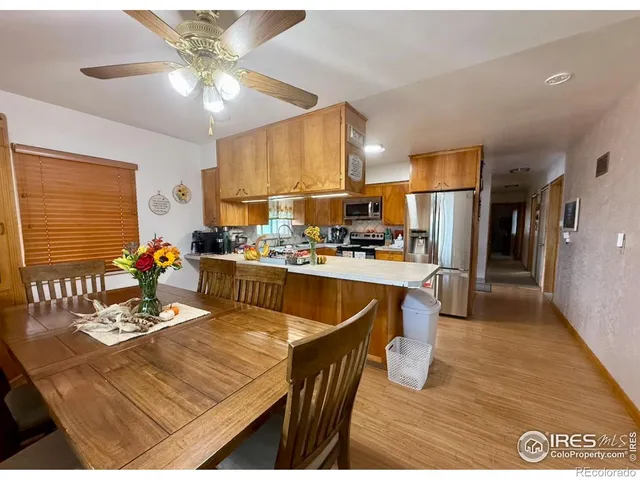 a room with stainless steel appliances kitchen island granite countertop furniture and a kitchen view