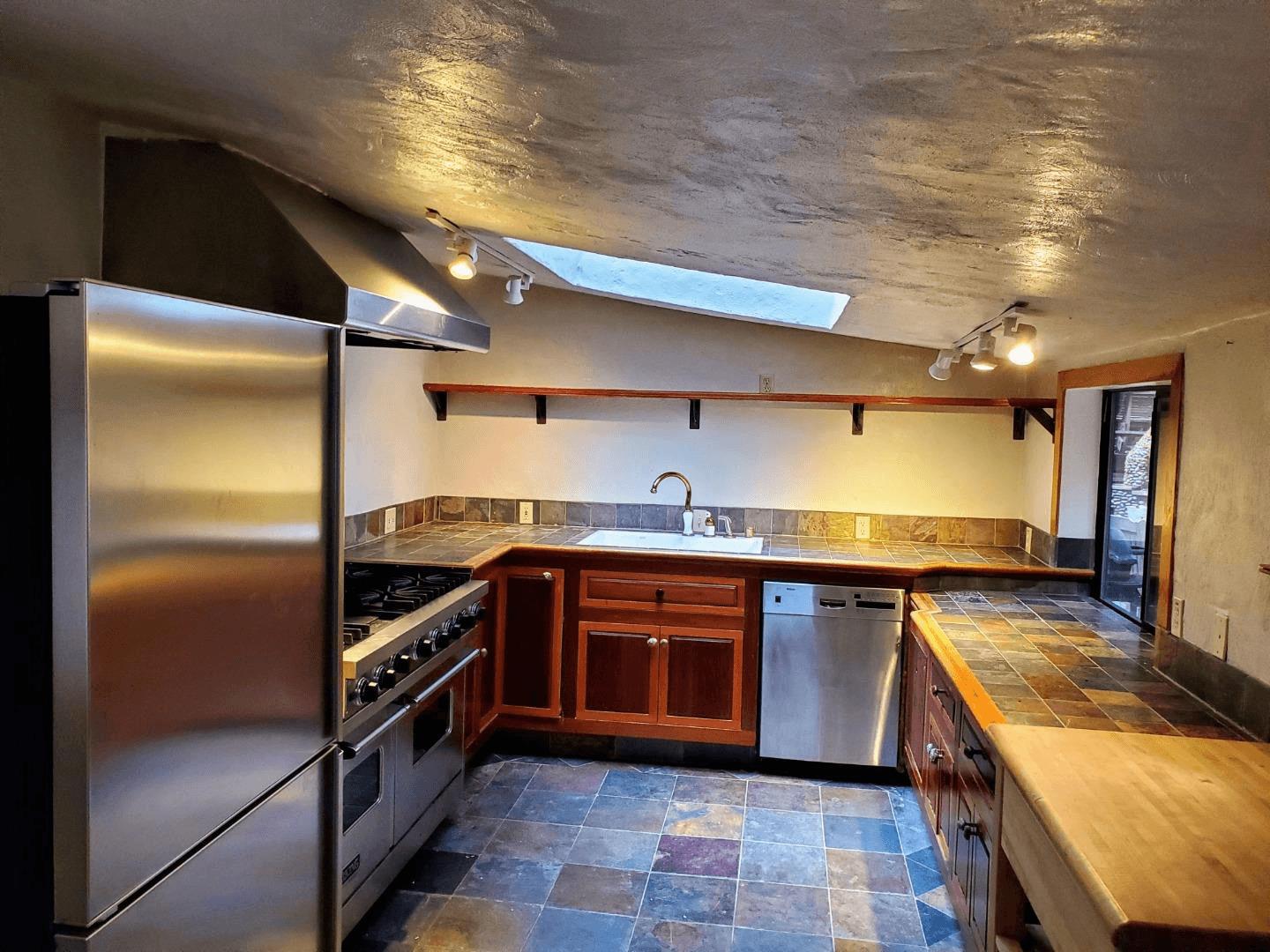 41 Back Road La Honda, CA 94020 - Photo 11 of 101 a large kitchen with stainless steel appliances granite countertop a sink and cabinets