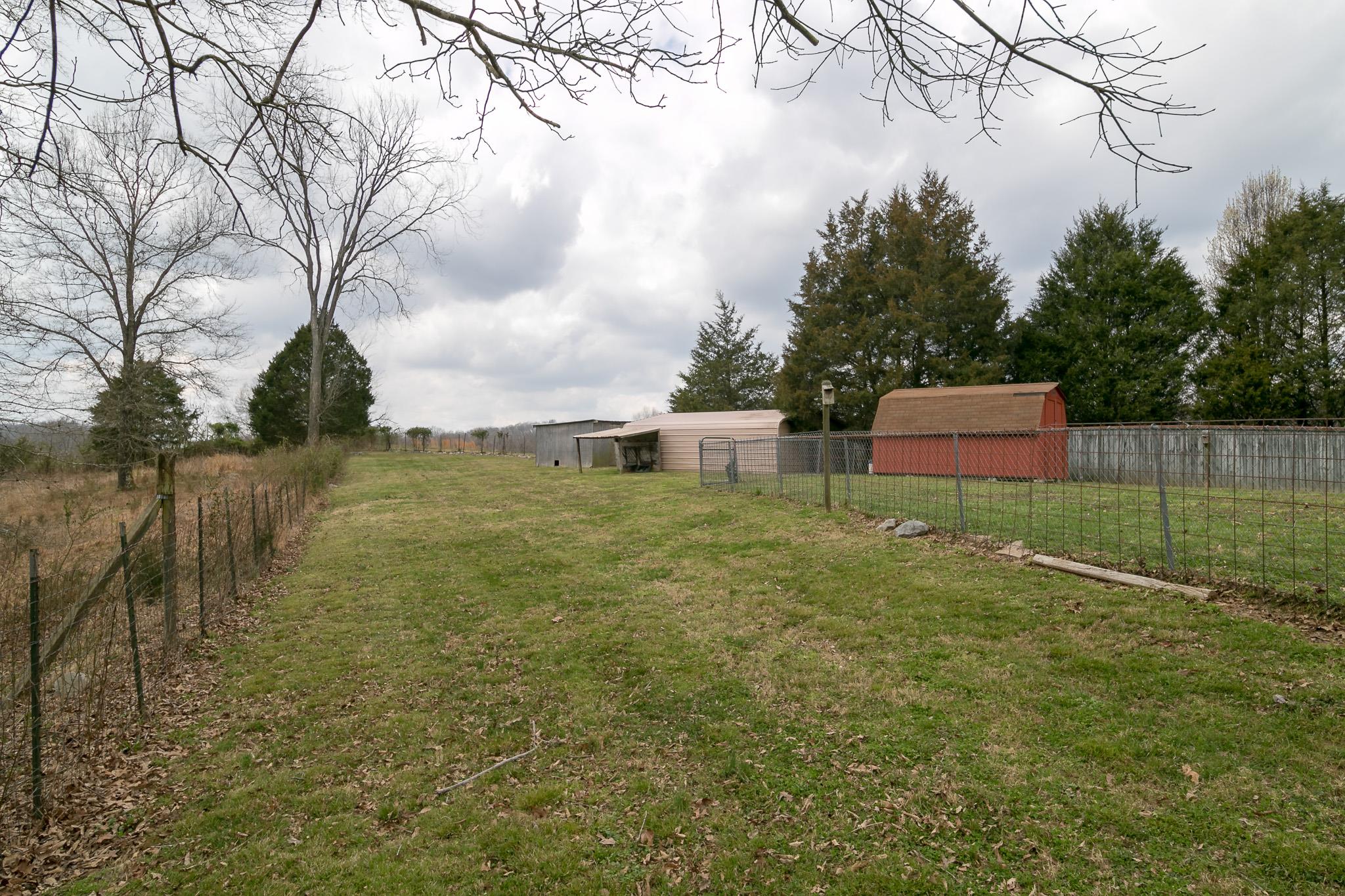 405 Gip Manning Road Clarksville, TN 37042 - Photo 22 of 26 Fenced in back yard and fenced pasture with buildings