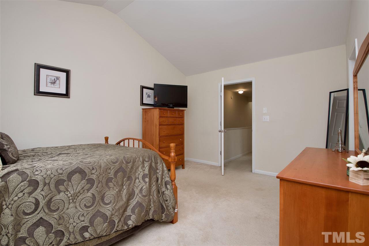 2135 Metacomet Way Raleigh, NC 27604 - Photo 15 of 25 a bedroom with a bed and a flat screen tv