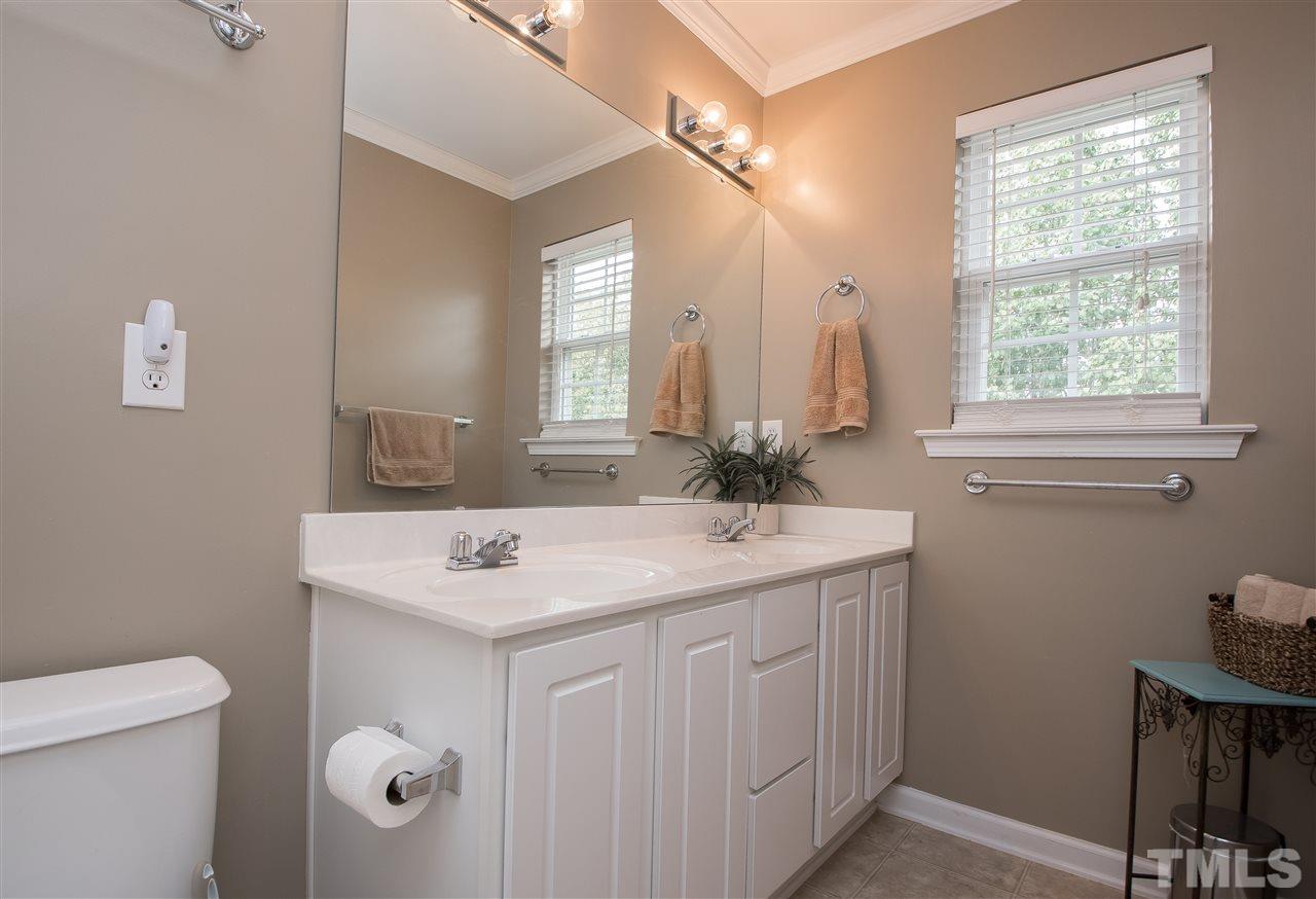 2135 Metacomet Way Raleigh, NC 27604 - Photo 16 of 25 a bathroom with a sink toilet and mirror