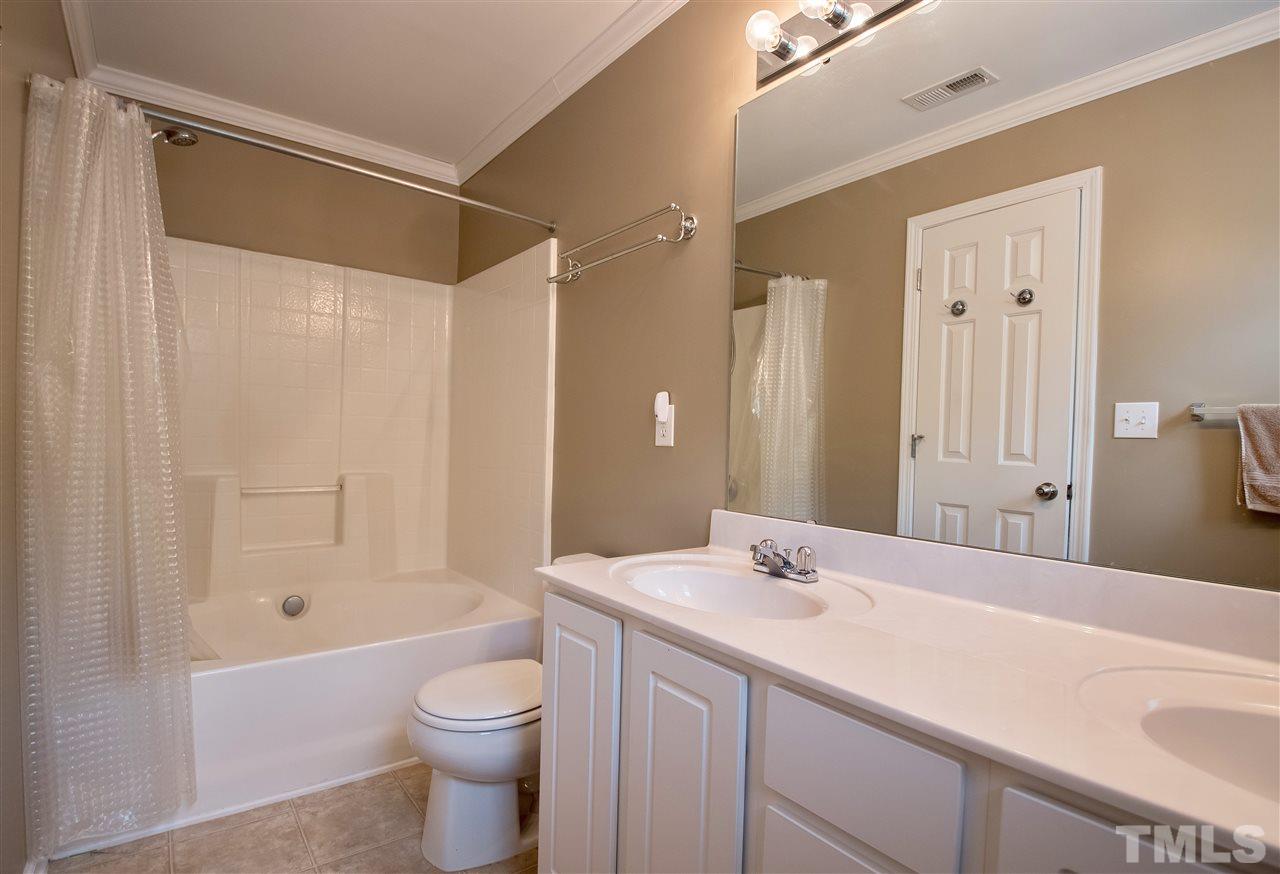 2135 Metacomet Way Raleigh, NC 27604 - Photo 17 of 25 a bathroom with a granite countertop sink toilet and shower
