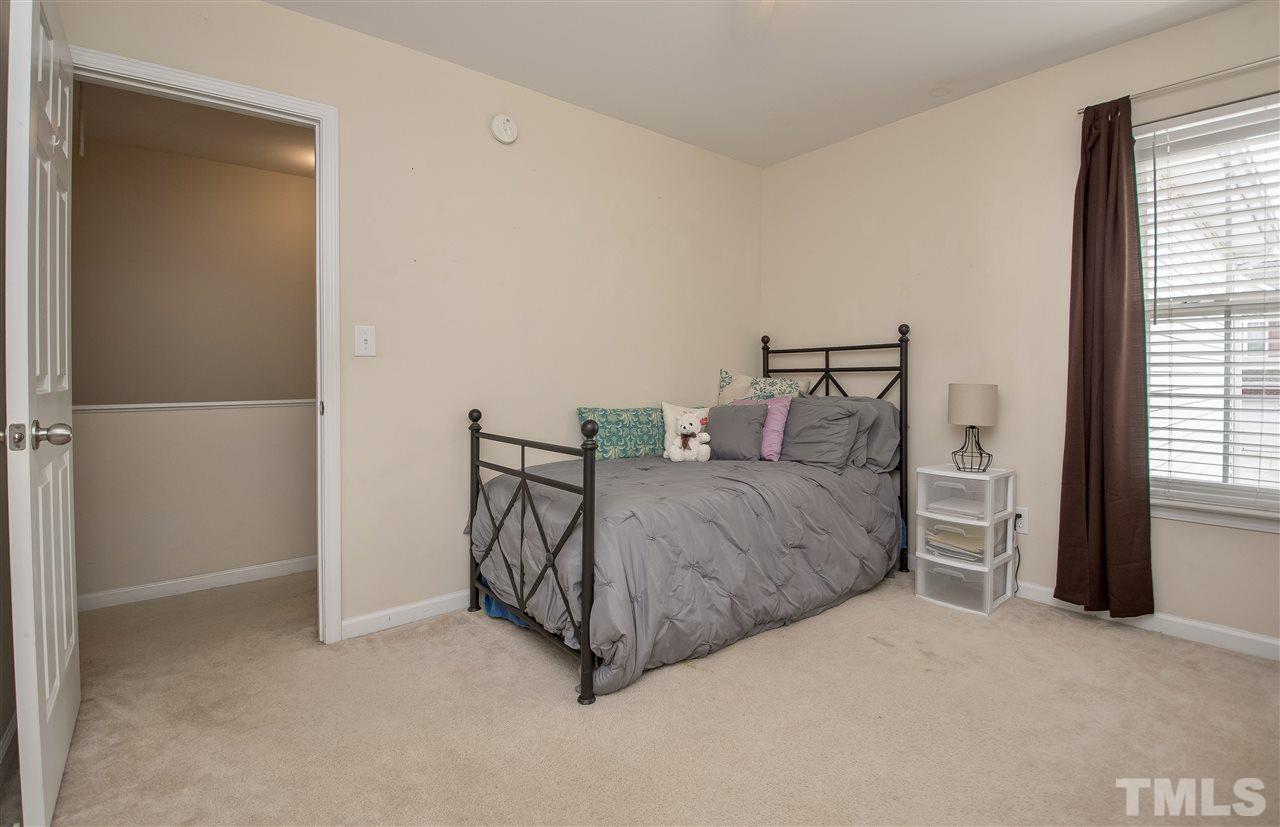 2135 Metacomet Way Raleigh, NC 27604 - Photo 19 of 25 a spacious bedroom with a bed and a window