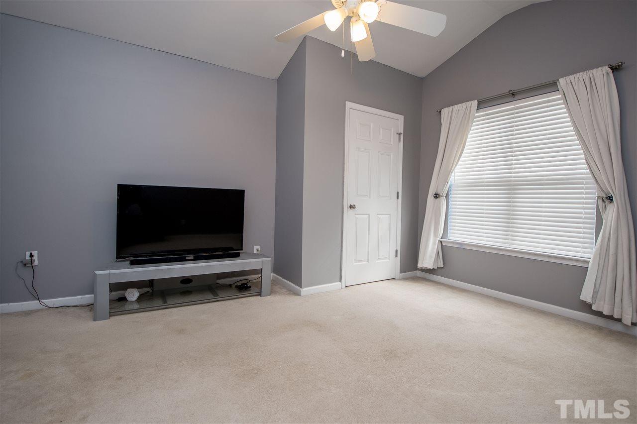 2135 Metacomet Way Raleigh, NC 27604 - Photo 20 of 25 a view of an empty room with a flat screen tv and a window