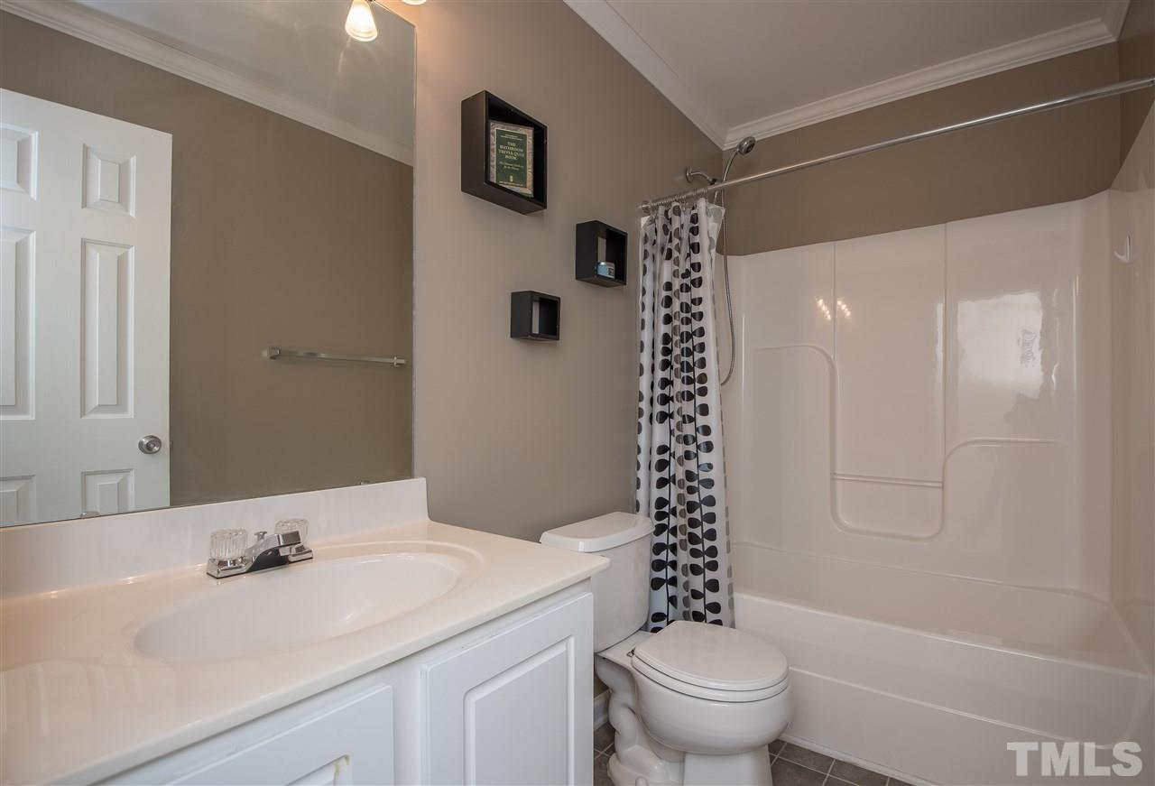 2135 Metacomet Way Raleigh, NC 27604 - Photo 21 of 25 a bathroom with a sink a toilet and shower
