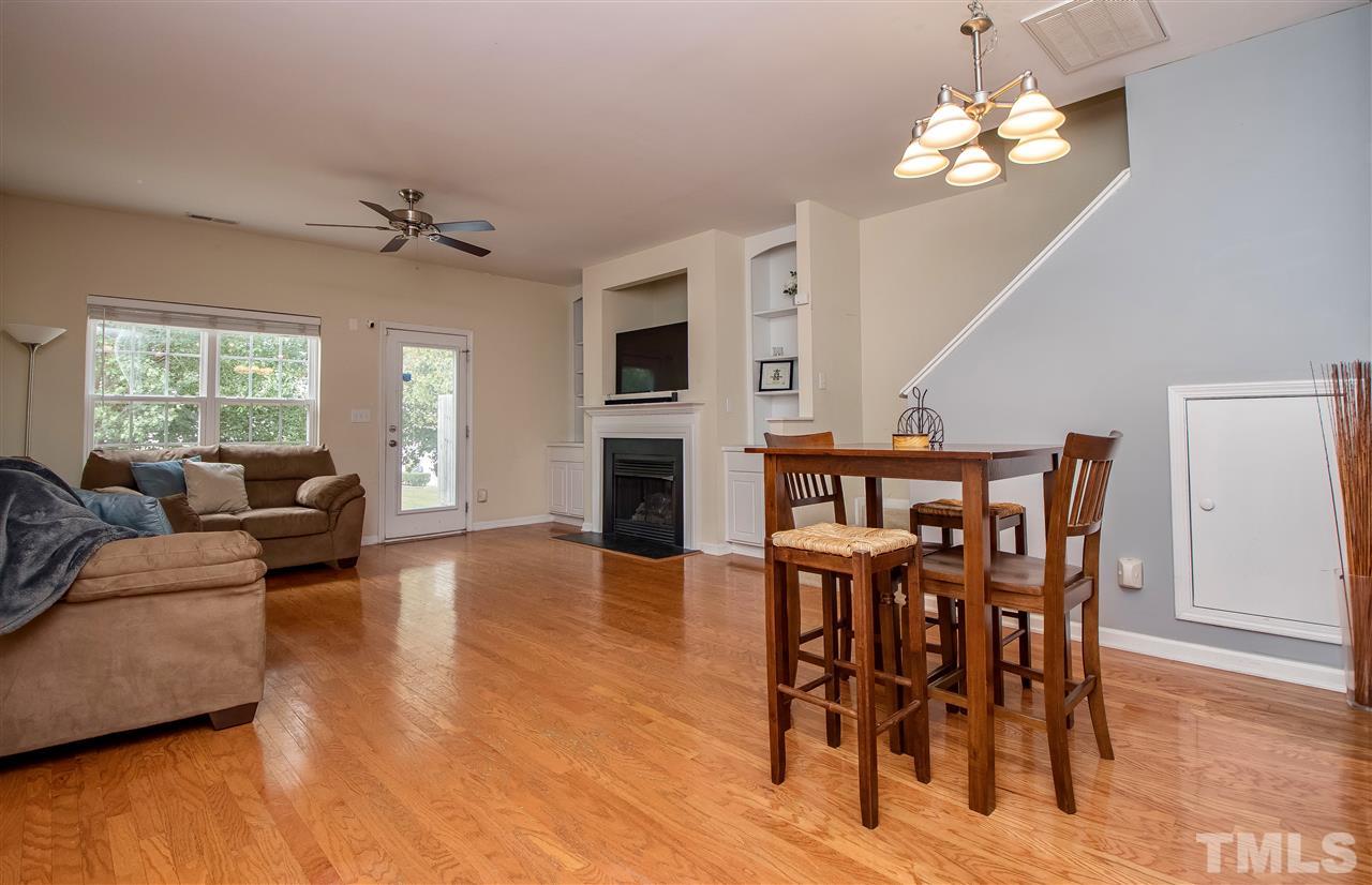 2135 Metacomet Way Raleigh, NC 27604 - Photo 4 of 25 a view of a dining room with furniture a chandelier and wooden floor