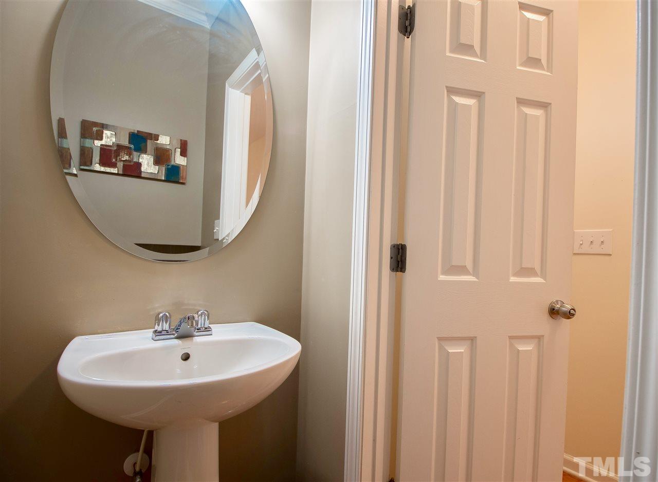 2135 Metacomet Way Raleigh, NC 27604 - Photo 8 of 25 a bathroom with a sink and a mirror