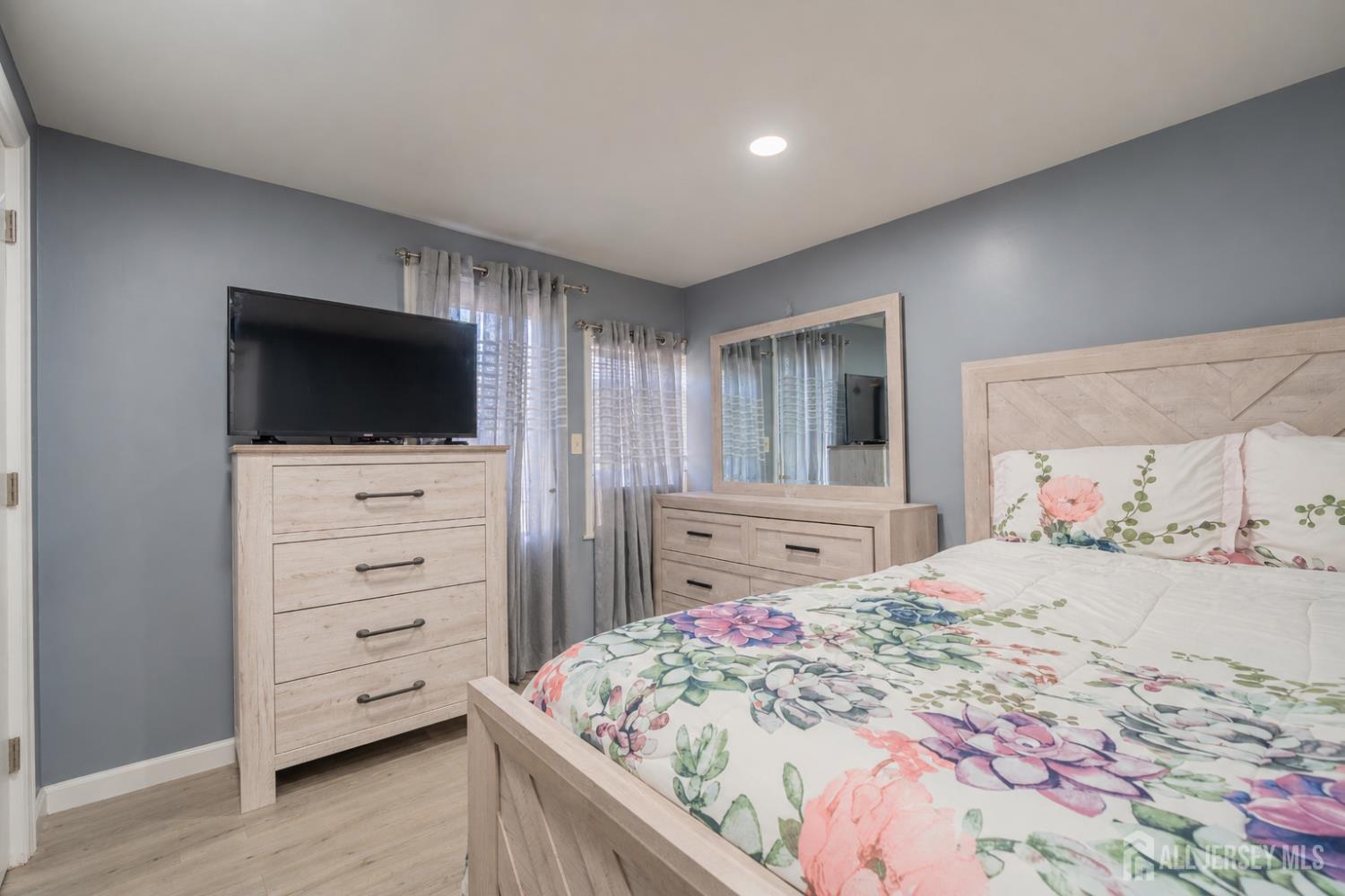 12 Pierrepont Avenue Middlesex, NJ 08846 - Photo 12 of 30 a bedroom with a bed and a flat screen tv in a dresser