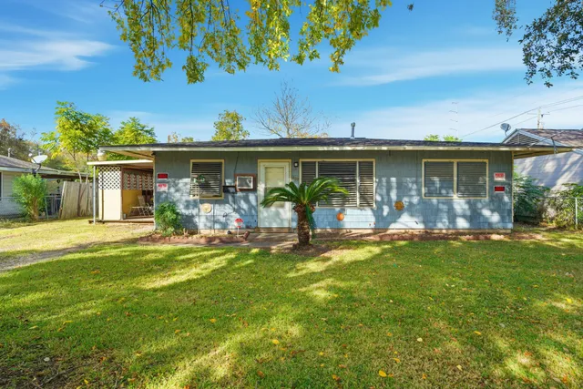 a view of a house with a yard porch and sitting area