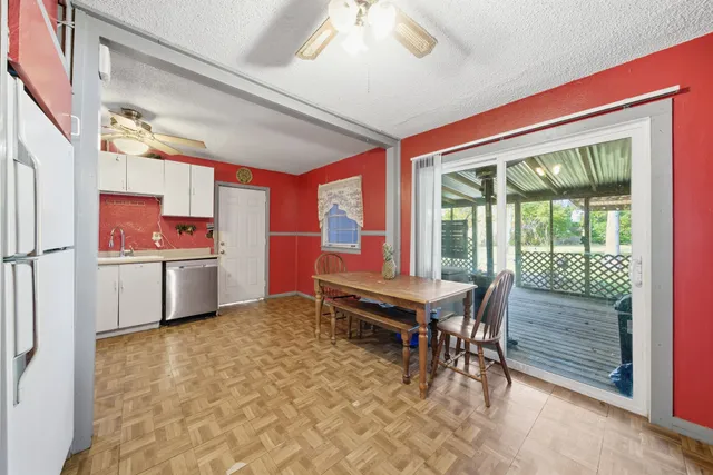 a kitchen with stainless steel appliances granite countertop a refrigerator a sink and dishwasher