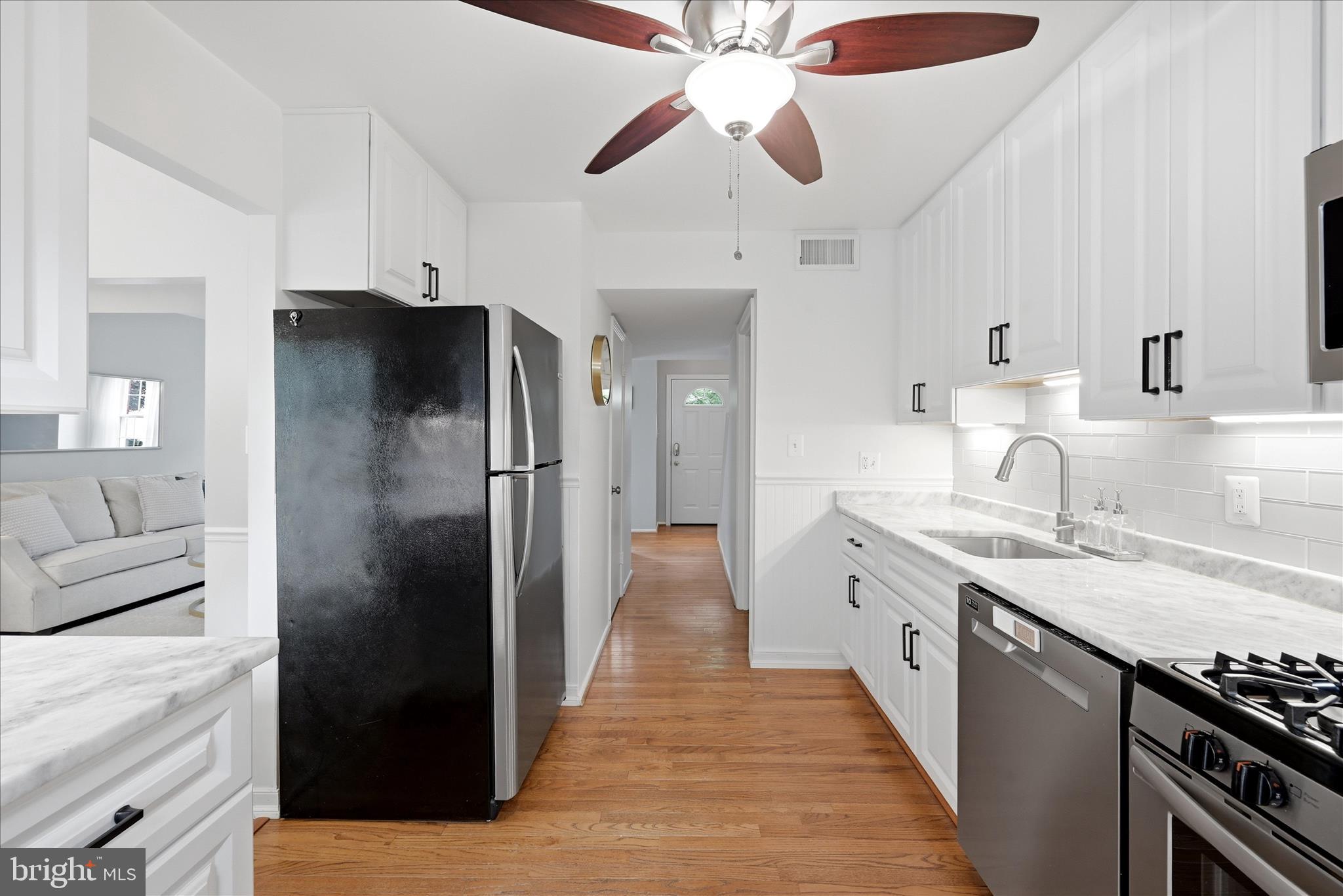 5446 Lighthouse Lane Burke, VA 22015 - Photo 10 of 36 a kitchen with stainless steel appliances granite countertop a refrigerator and a sink