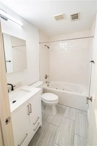 a bathroom with a sink a toilet and mirror
