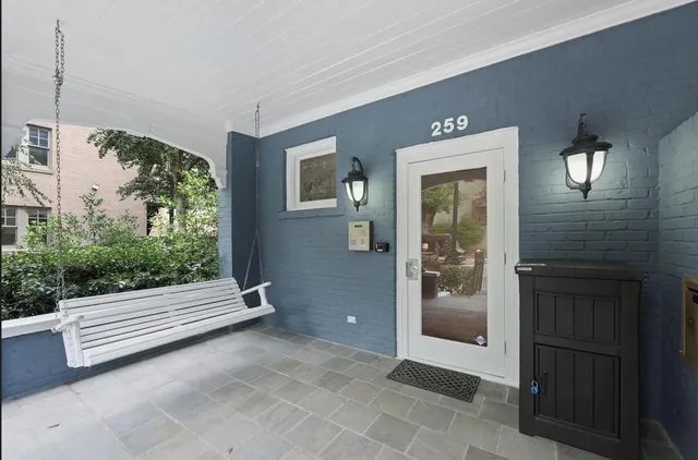 a view of front door and a yard