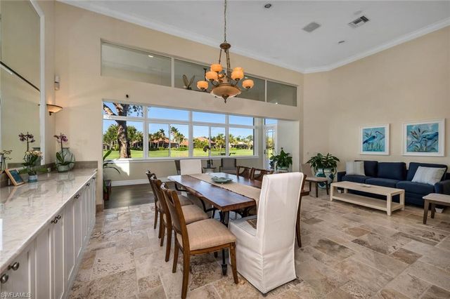 a dining room with furniture a rug and a chandelier