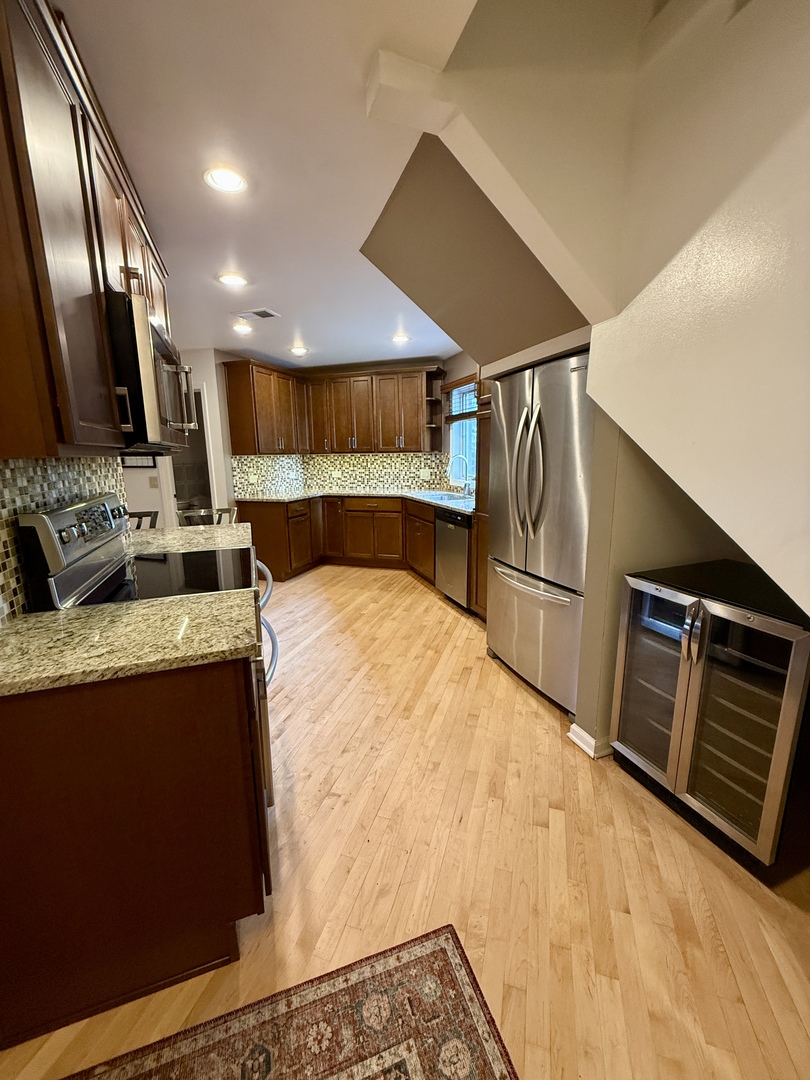414 South Dee Road Park Ridge, IL 60068 - Photo 6 of 37 a kitchen with stainless steel appliances kitchen island granite countertop a refrigerator and a stove top oven