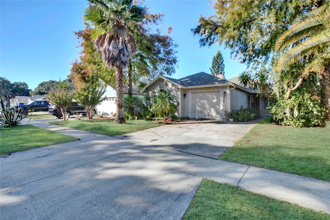 a front view of a house with a yard and a garage