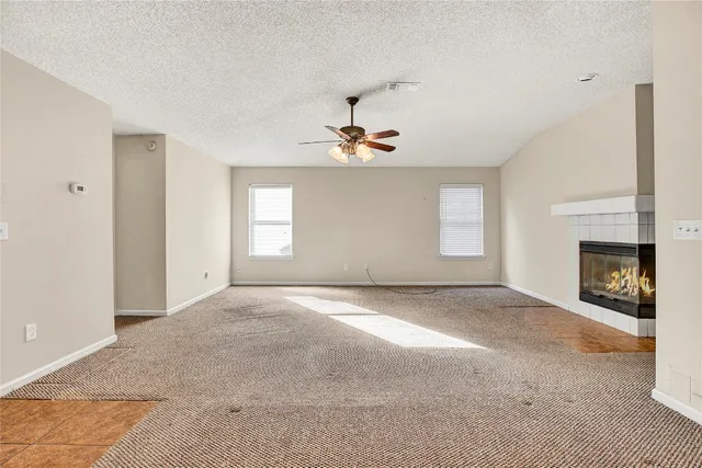 a view of a livingroom with a fireplace and window
