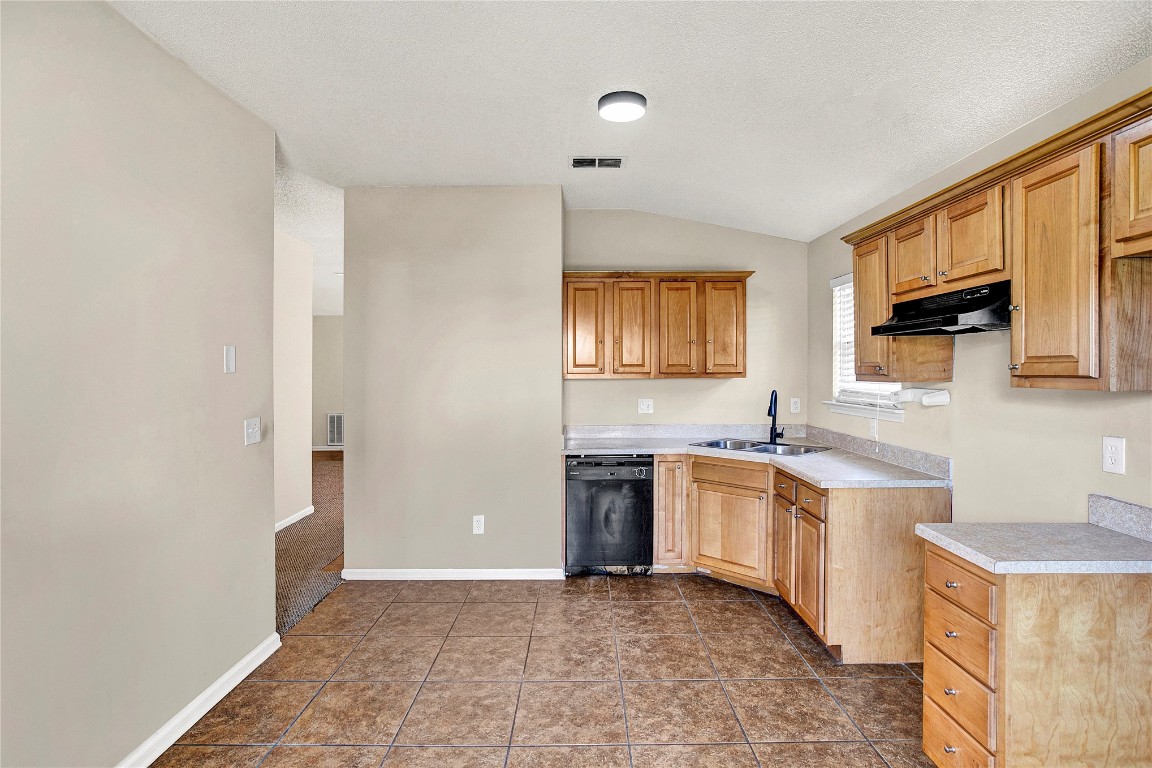 909 Gavagan Road Jacksonville, FL 32233 - Photo 4 of 17 a kitchen with stainless steel appliances granite countertop a stove a sink and a refrigerator