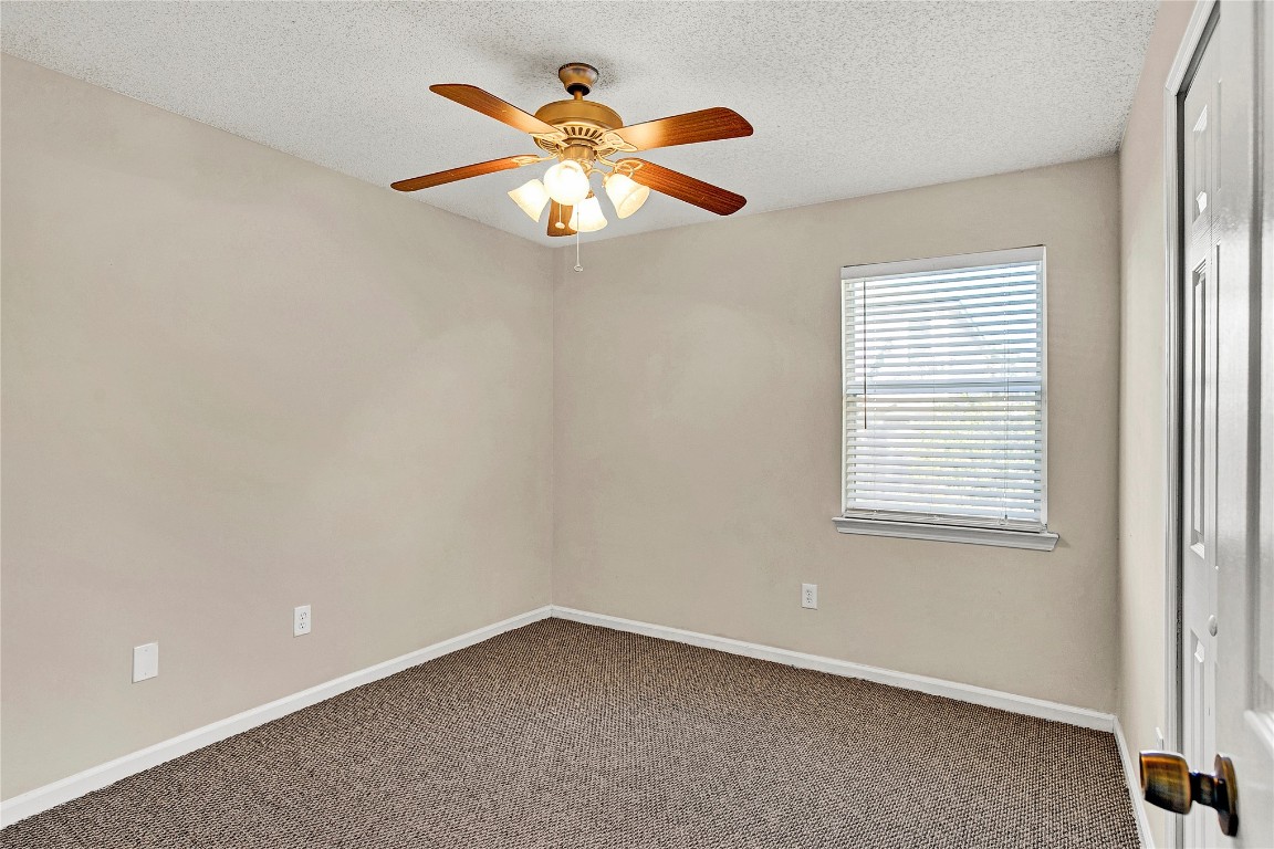 909 Gavagan Road Jacksonville, FL 32233 - Photo 5 of 17 an empty room with a window and a fan